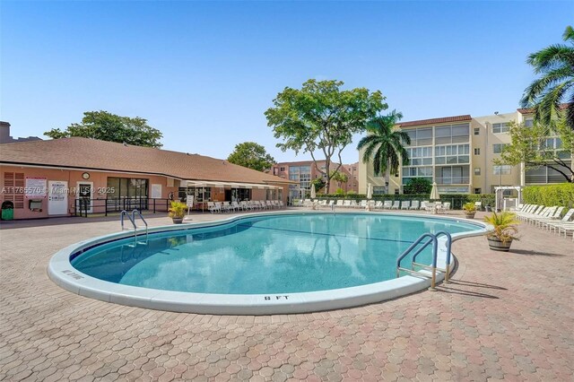 2811 Somerset Dr Unit 405, Lauderdale Lakes, FL 33311 - community pool featuring a patio and fence
