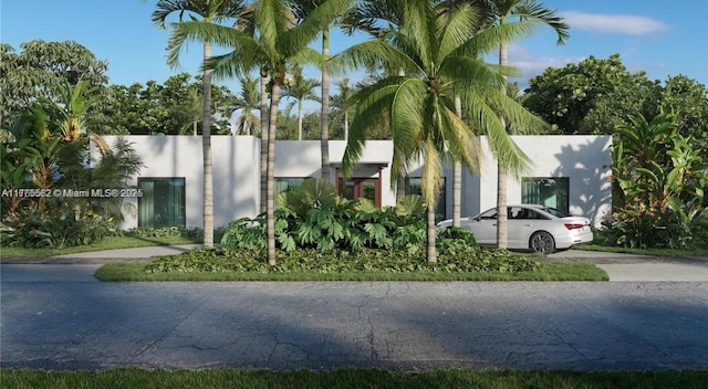1961 NE 186th Dr, North Miami Beach, FL 33179 - view of front of home with stucco siding and concrete driveway