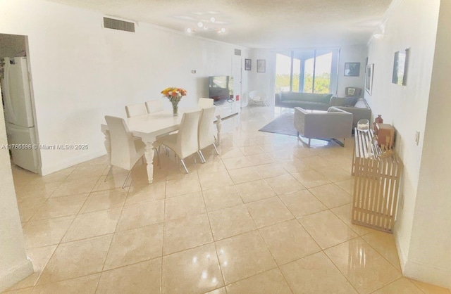 9801 Collins Ave Unit 8M, Bal Harbour, FL 33154 - dining area with light tile patterned flooring and ornamental molding