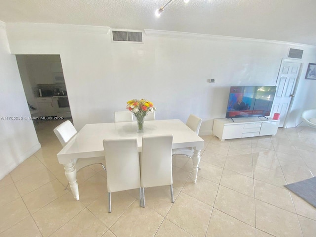 9801 Collins Ave Unit 8M, Bal Harbour, FL 33154 - dining room with ornamental molding, light tile patterned floors, and a textured ceiling