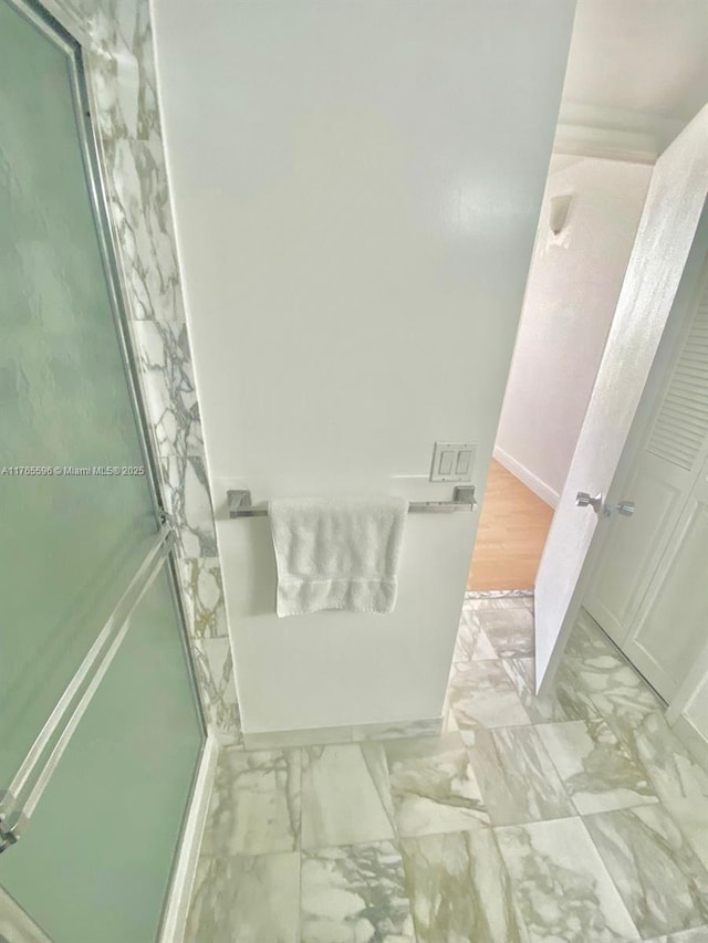 9801 Collins Ave Unit 8M, Bal Harbour, FL 33154 - bathroom with marble look tile flooring and a shower stall
