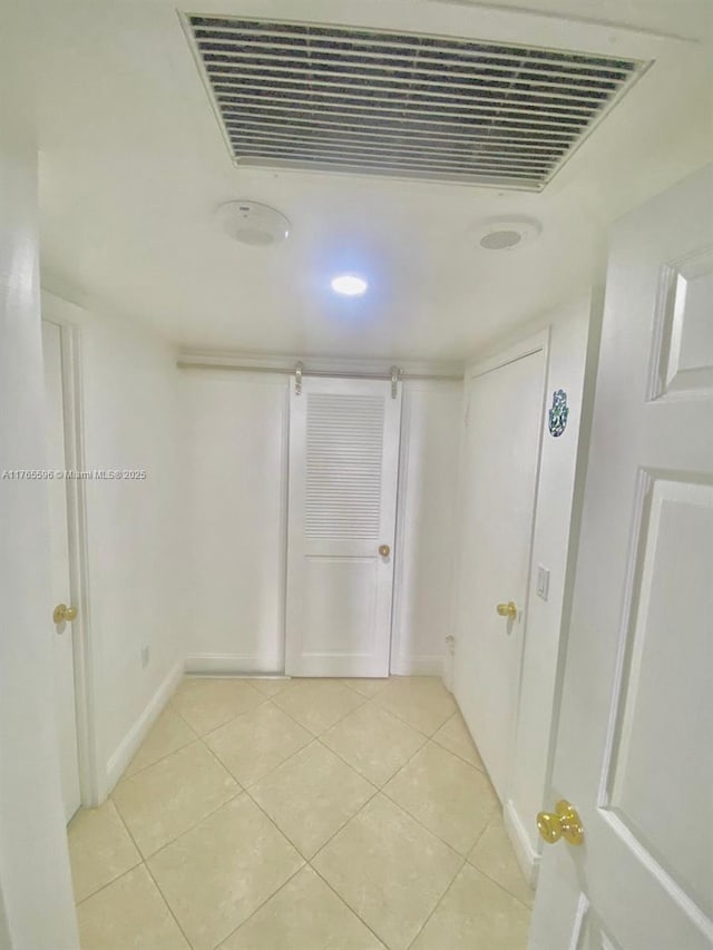 9801 Collins Ave Unit 8M, Bal Harbour, FL 33154 - hallway with light tile patterned floors and baseboards