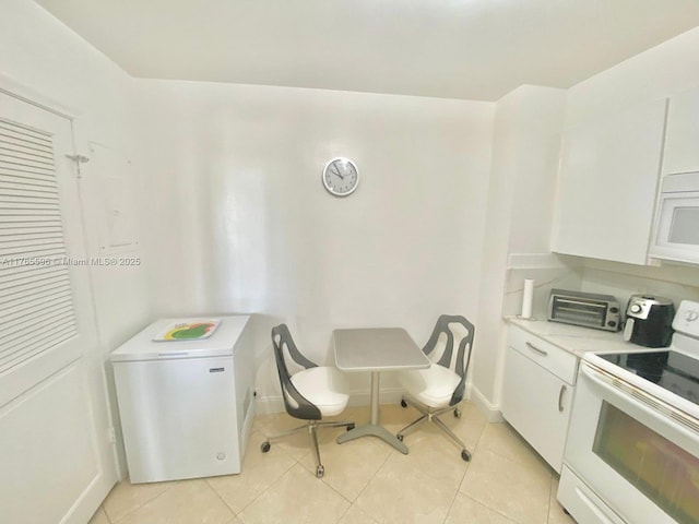 9801 Collins Ave Unit 8M, Bal Harbour, FL 33154 - kitchen featuring white appliances, white cabinets, and light tile patterned floors
