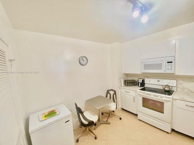 9801 Collins Ave Unit 8M, Bal Harbour, FL 33154 - kitchen featuring white appliances, white cabinets, and light countertops