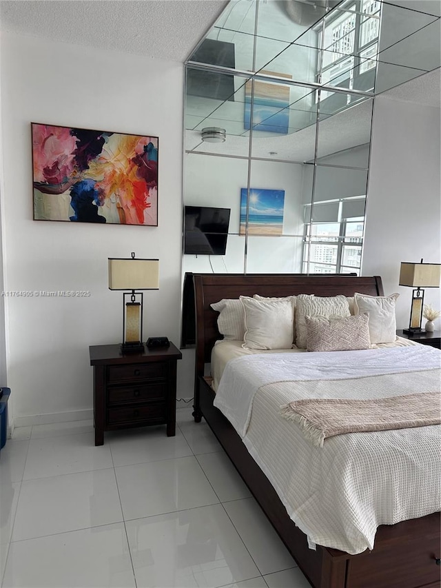 18041 Biscayne Blvd Unit Ph02, Aventura, FL 33160 - tiled bedroom with a textured ceiling