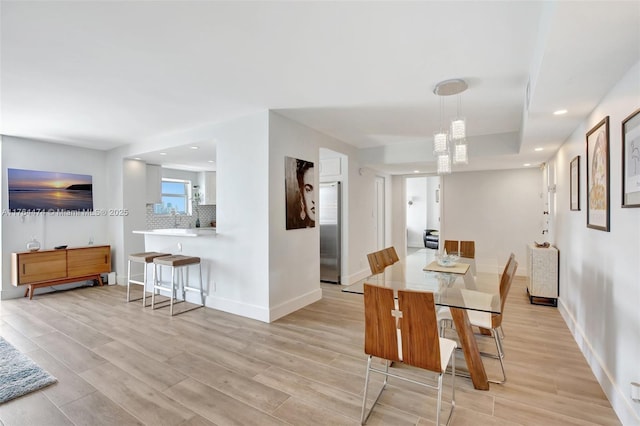 dining area with recessed lighting, baseboards, and light wood finished floors
