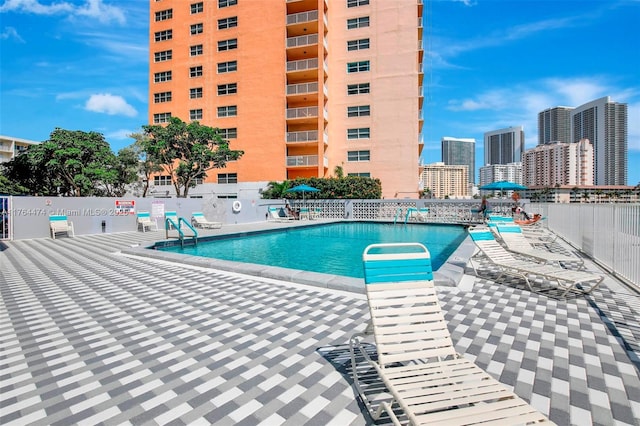 pool with a view of city and fence