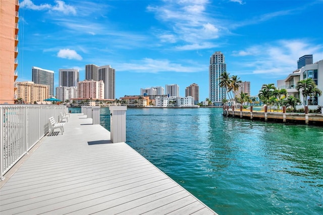 view of dock featuring a view of city and a water view