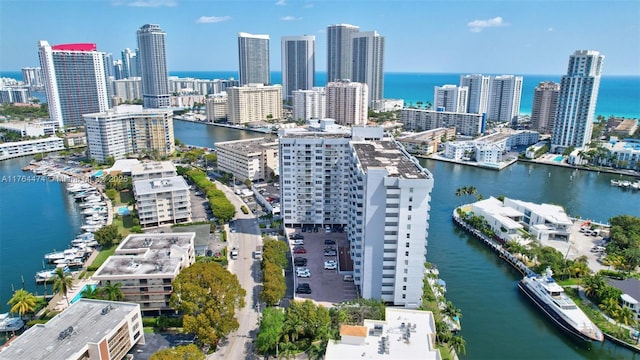birds eye view of property featuring a city view and a water view