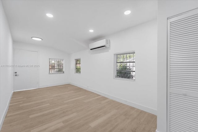 2911 NW 30th St, Miami, FL 33142 - spare room with recessed lighting, light wood-style flooring, an AC wall unit, and baseboards