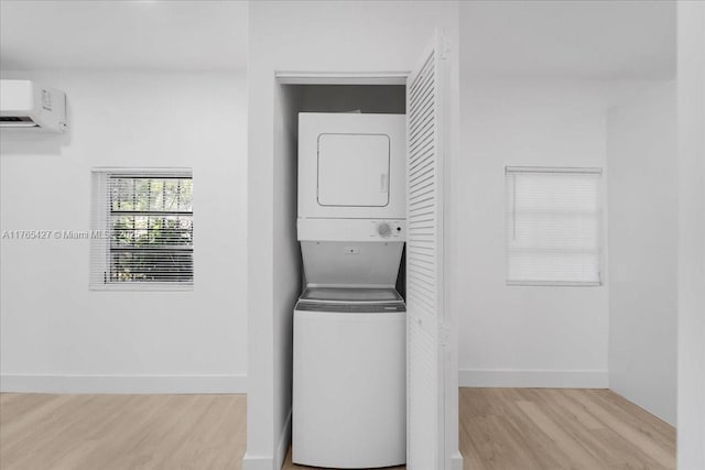 2911 NW 30th St, Miami, FL 33142 - laundry area featuring baseboards, a wall mounted air conditioner, laundry area, wood finished floors, and stacked washer / drying machine