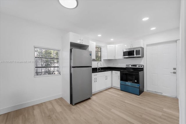 2911 NW 30th St, Miami, FL 33142 - kitchen with light wood finished floors, plenty of natural light, appliances with stainless steel finishes, and a sink