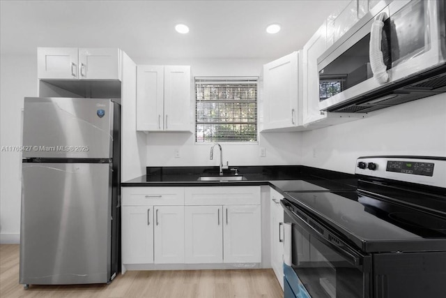 2911 NW 30th St, Miami, FL 33142 - kitchen with a sink, light wood finished floors, appliances with stainless steel finishes, and white cabinetry
