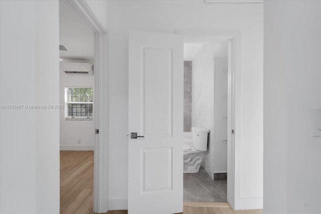 2911 NW 30th St, Miami, FL 33142 - hallway with baseboards, a wall mounted AC, and light wood finished floors