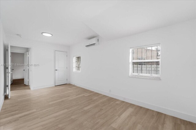 2911 NW 30th St, Miami, FL 33142 - spare room featuring a wealth of natural light, light wood finished floors, and an AC wall unit