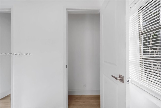 2911 NW 30th St, Miami, FL 33142 - hallway featuring light wood-style flooring and baseboards