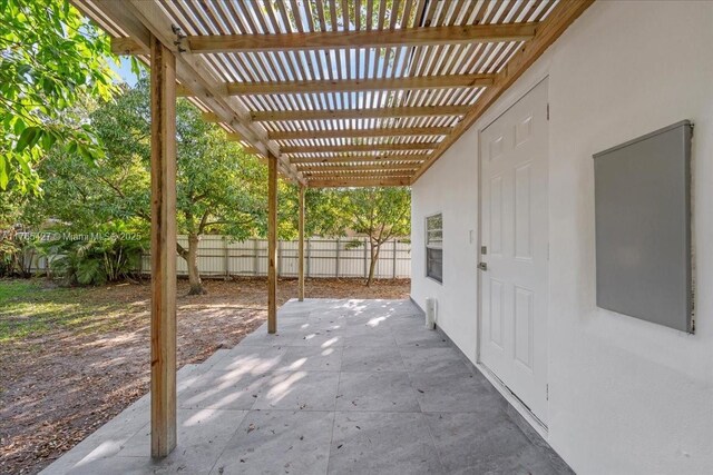 2911 NW 30th St, Miami, FL 33142 - view of patio / terrace with a pergola and fence
