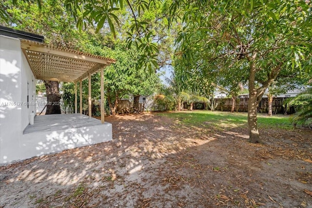 2911 NW 30th St, Miami, FL 33142 - view of yard with a fenced backyard and a pergola
