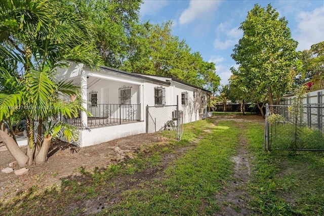 2911 NW 30th St, Miami, FL 33142 - view of property exterior featuring a yard, stucco siding, and a fenced backyard