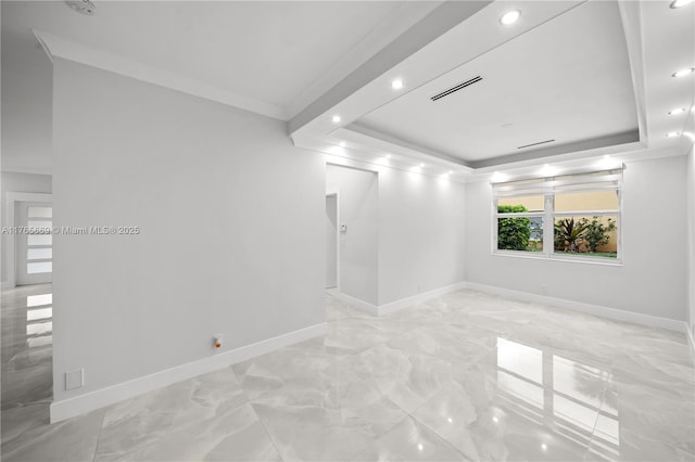 empty room featuring a raised ceiling, baseboards, marble finish floor, and ornamental molding