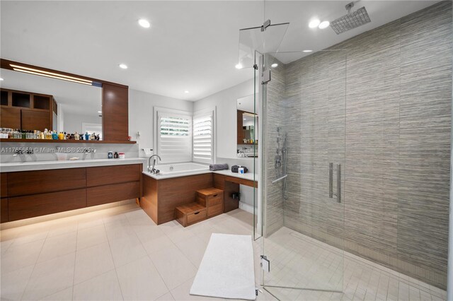bathroom featuring a bath, tile patterned flooring, a shower stall, and double vanity