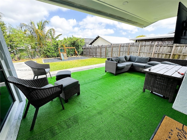 view of yard featuring a fenced backyard, a playground, and outdoor lounge area