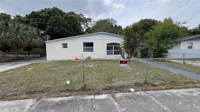 607 N 19th St, Fort Pierce, FL 34950 - view of front of home with a fenced front yard and a front lawn