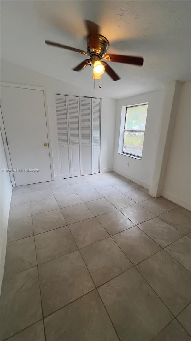 607 N 19th St, Fort Pierce, FL 34950 - unfurnished bedroom with light tile patterned floors, baseboards, and ceiling fan