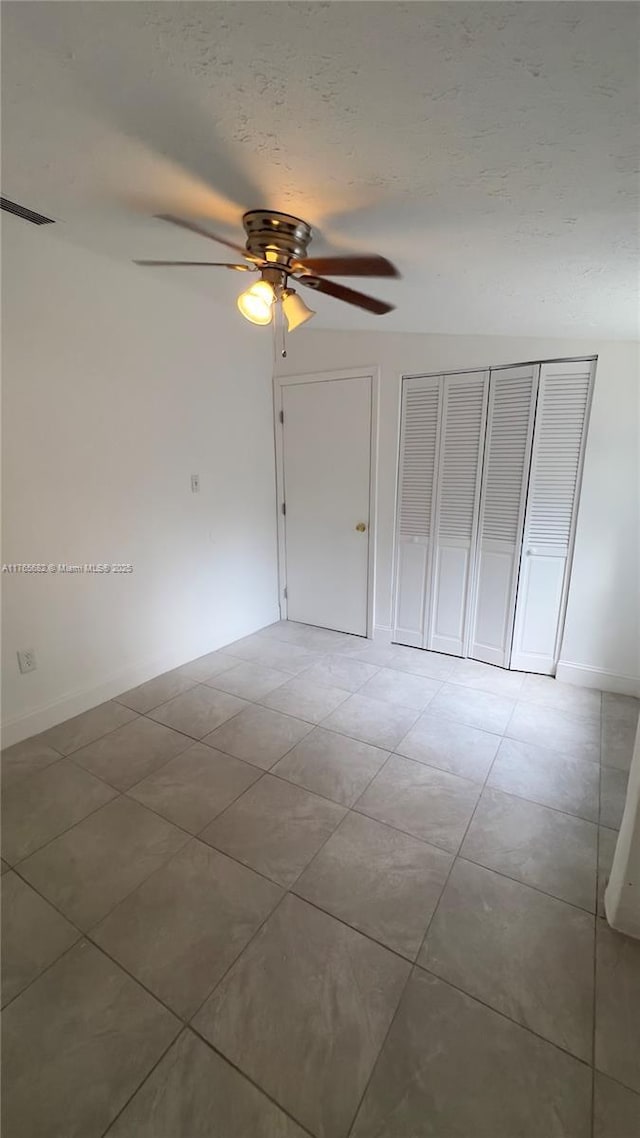 607 N 19th St, Fort Pierce, FL 34950 - interior space featuring light tile patterned floors, a closet, a textured ceiling, and ceiling fan