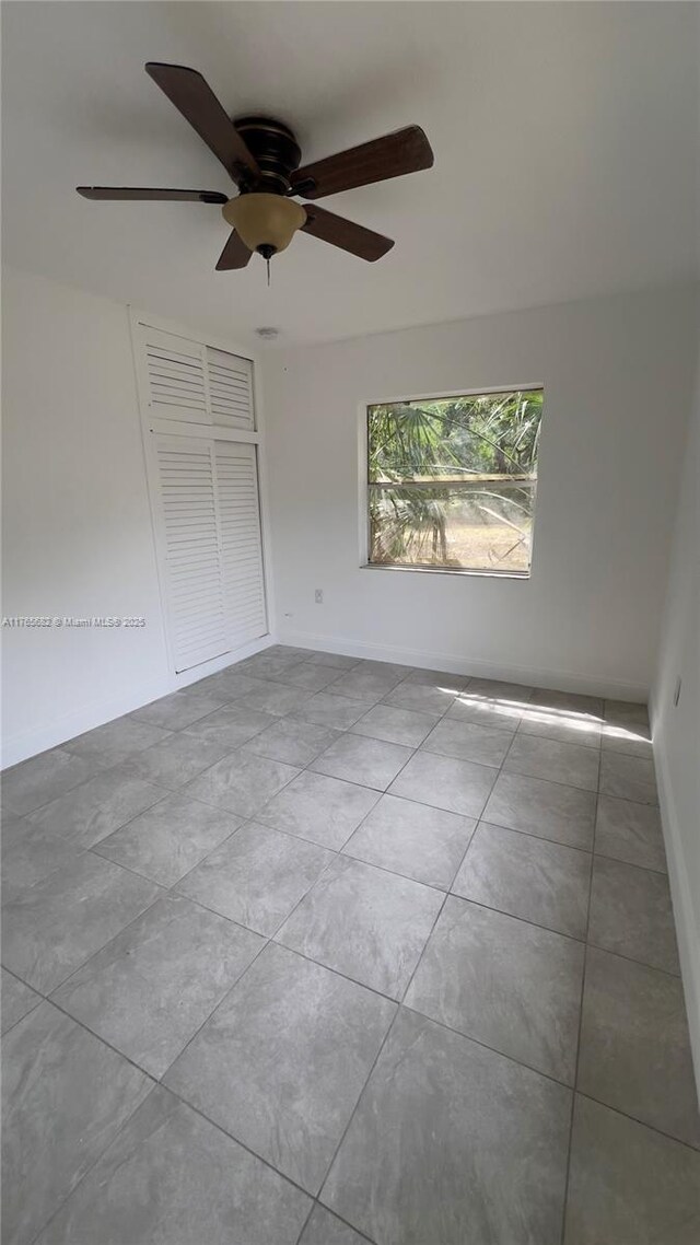 607 N 19th St, Fort Pierce, FL 34950 - tiled empty room featuring baseboards and a ceiling fan