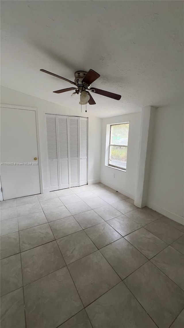 607 N 19th St, Fort Pierce, FL 34950 - unfurnished bedroom featuring ceiling fan, baseboards, and light tile patterned flooring
