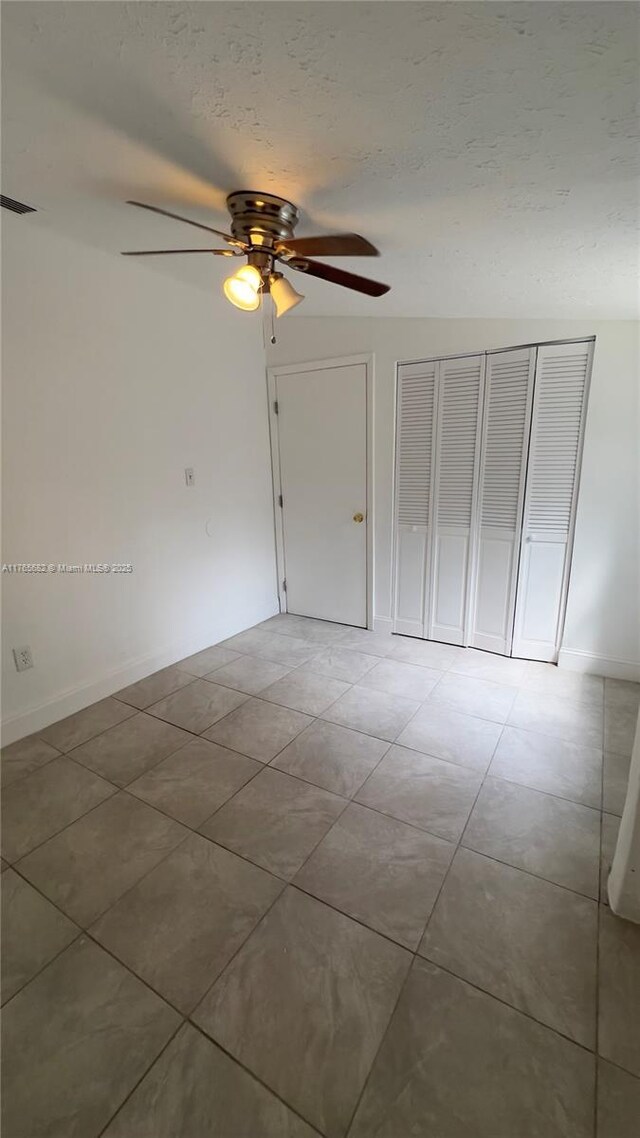 607 N 19th St, Fort Pierce, FL 34950 - empty room featuring a textured ceiling, light tile patterned flooring, and ceiling fan