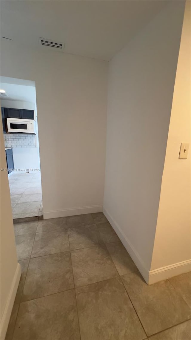 607 N 19th St, Fort Pierce, FL 34950 - hall featuring light tile patterned floors, baseboards, and visible vents