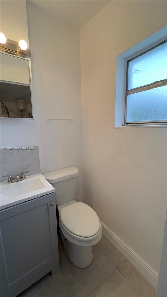 607 N 19th St, Fort Pierce, FL 34950 - bathroom featuring tile patterned floors, baseboards, toilet, and vanity