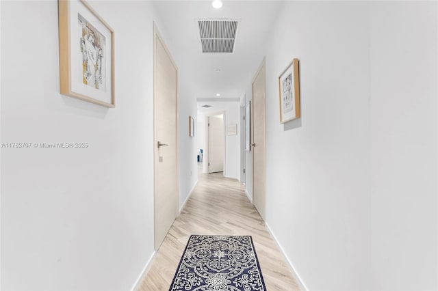 corridor featuring visible vents, recessed lighting, baseboards, and light wood-style floors
