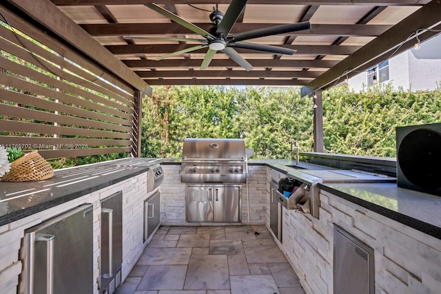 view of patio / terrace featuring a grill, exterior kitchen, and a ceiling fan