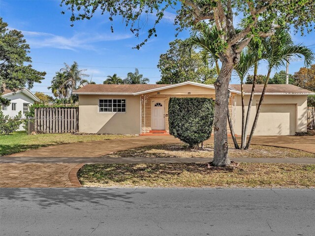 4401 Johnson St, Hollywood, FL 33021 - view of front facade with concrete driveway, an attached garage, fence, and stucco siding