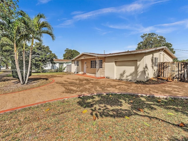 4401 Johnson St, Hollywood, FL 33021 - ranch-style home featuring stucco siding, driveway, and fence