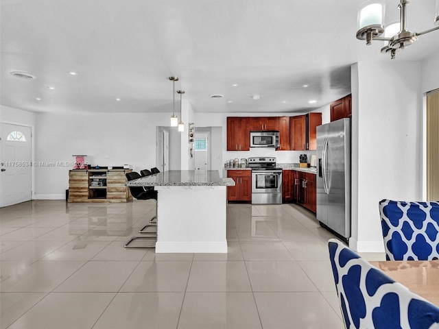 4401 Johnson St, Hollywood, FL 33021 - kitchen with dark brown cabinets, appliances with stainless steel finishes, open floor plan, and light tile patterned floors