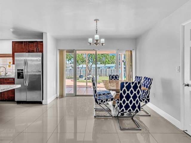 4401 Johnson St, Hollywood, FL 33021 - dining space with light tile patterned flooring, baseboards, and an inviting chandelier