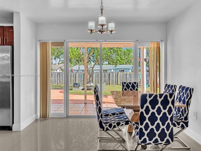 4401 Johnson St, Hollywood, FL 33021 - tiled dining space featuring an inviting chandelier and baseboards