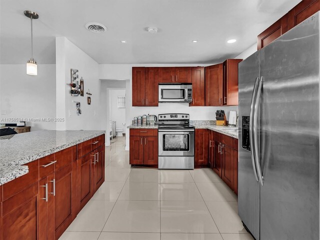 4401 Johnson St, Hollywood, FL 33021 - kitchen with light tile patterned flooring, visible vents, reddish brown cabinets, and stainless steel appliances