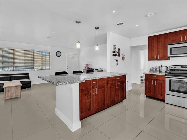 4401 Johnson St, Hollywood, FL 33021 - kitchen featuring visible vents, light tile patterned floors, light stone counters, stainless steel appliances, and reddish brown cabinets