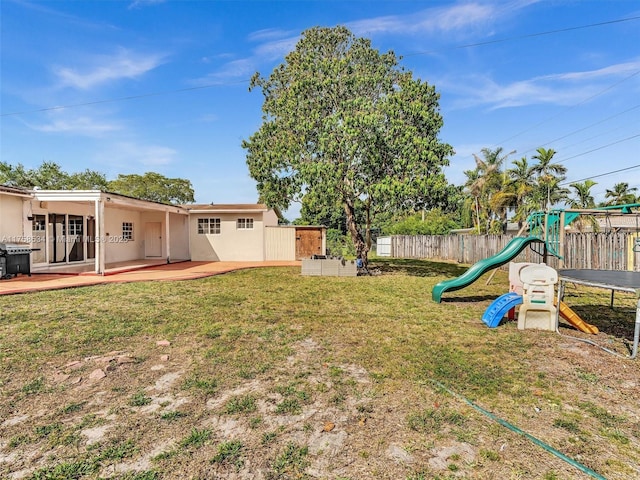 4401 Johnson St, Hollywood, FL 33021 - view of yard featuring a patio area, a playground, and fence