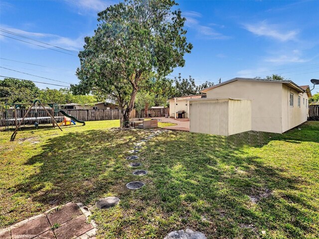 4401 Johnson St, Hollywood, FL 33021 - view of yard with a playground and a fenced backyard