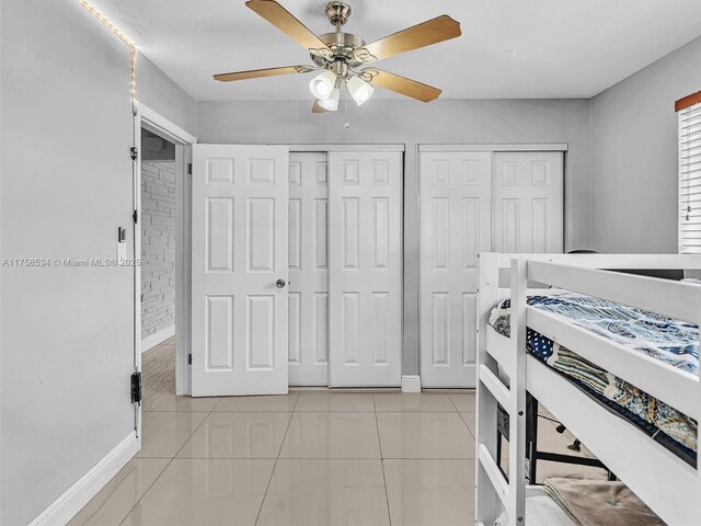 4401 Johnson St, Hollywood, FL 33021 - bedroom featuring light tile patterned floors, baseboards, multiple closets, and a ceiling fan