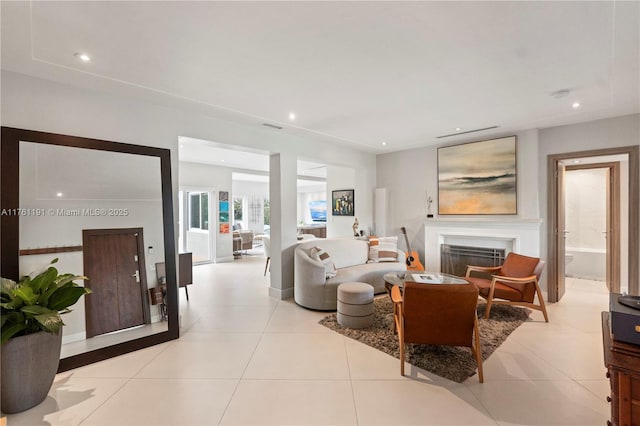 living area with light tile patterned floors, a fireplace, and recessed lighting