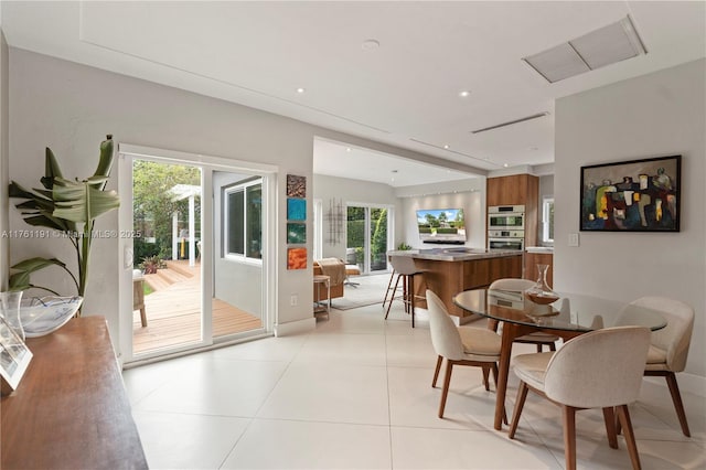 dining area featuring light tile patterned flooring and recessed lighting