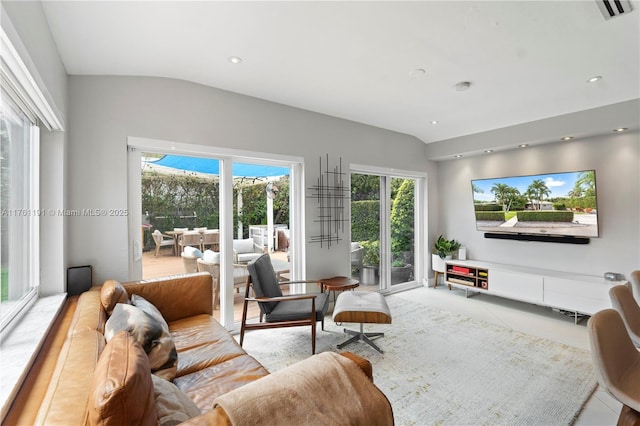 living area featuring visible vents, vaulted ceiling, and recessed lighting
