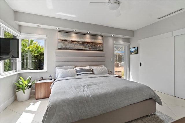 bedroom featuring visible vents, baseboards, ceiling fan, tile patterned floors, and access to exterior